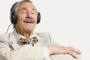 Elderly Man Listening to Music --- Image by © Image Source/Corbis